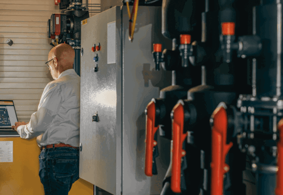 Man Monitoring The Building Installation Performance And Heat Network